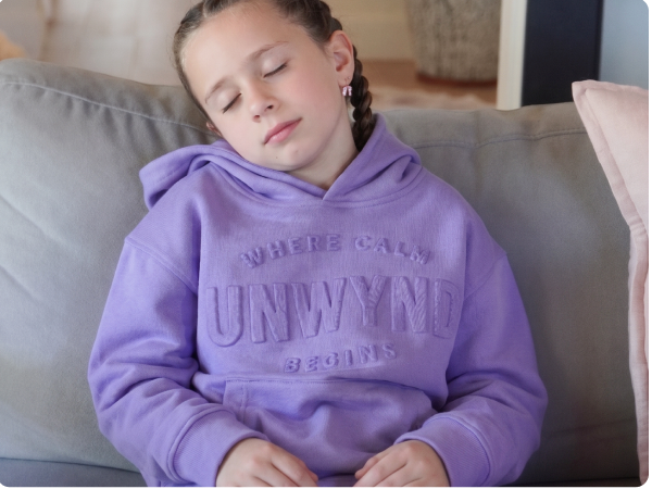 young boy sleeping wearing a hoodie