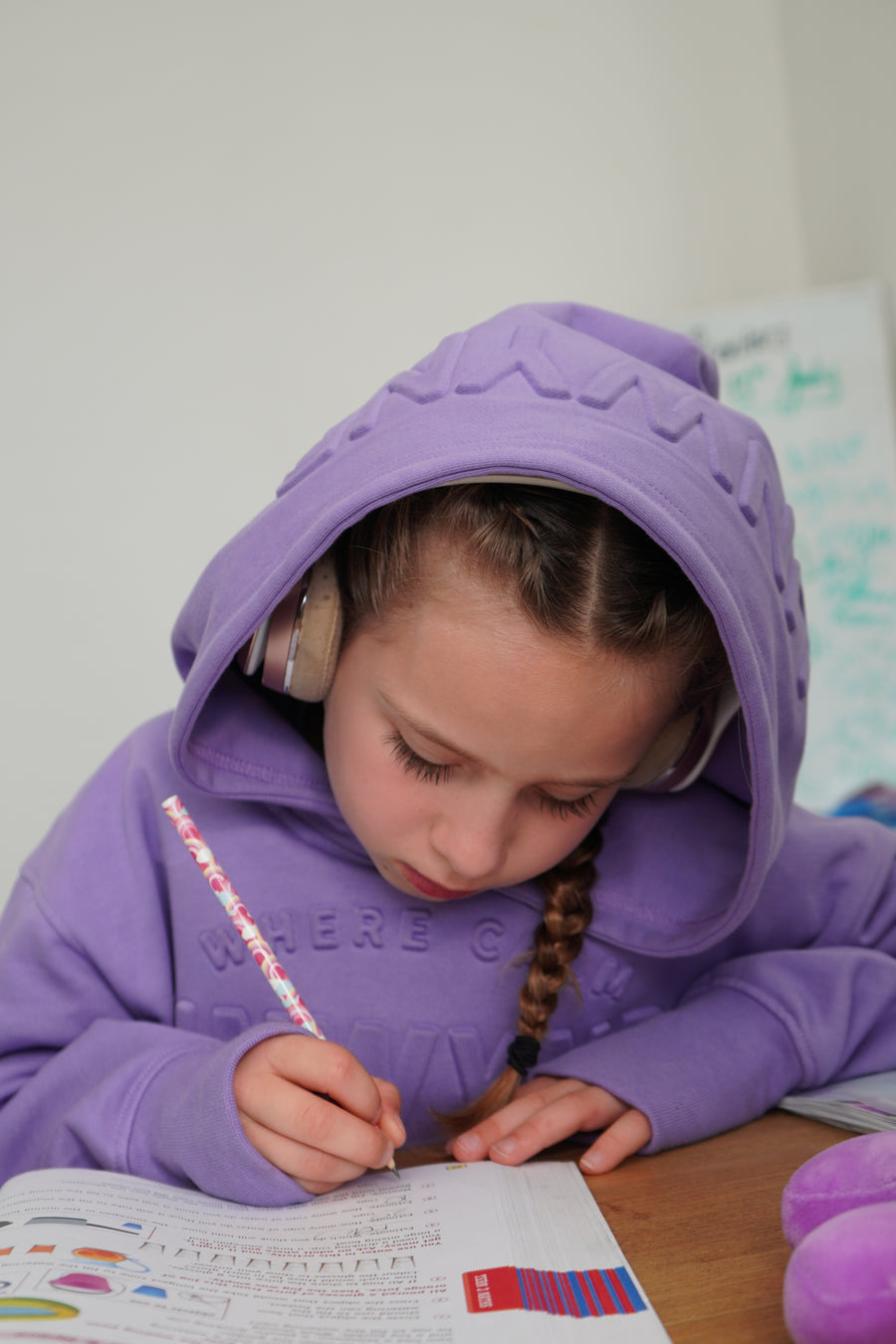 young boy wearing hoodie pulling the collar