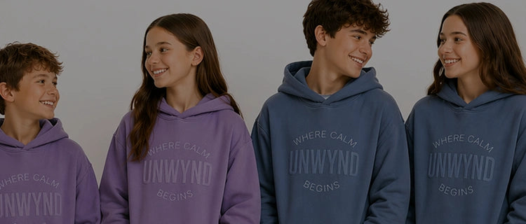 teenagers wearing hoodie smiling at each other