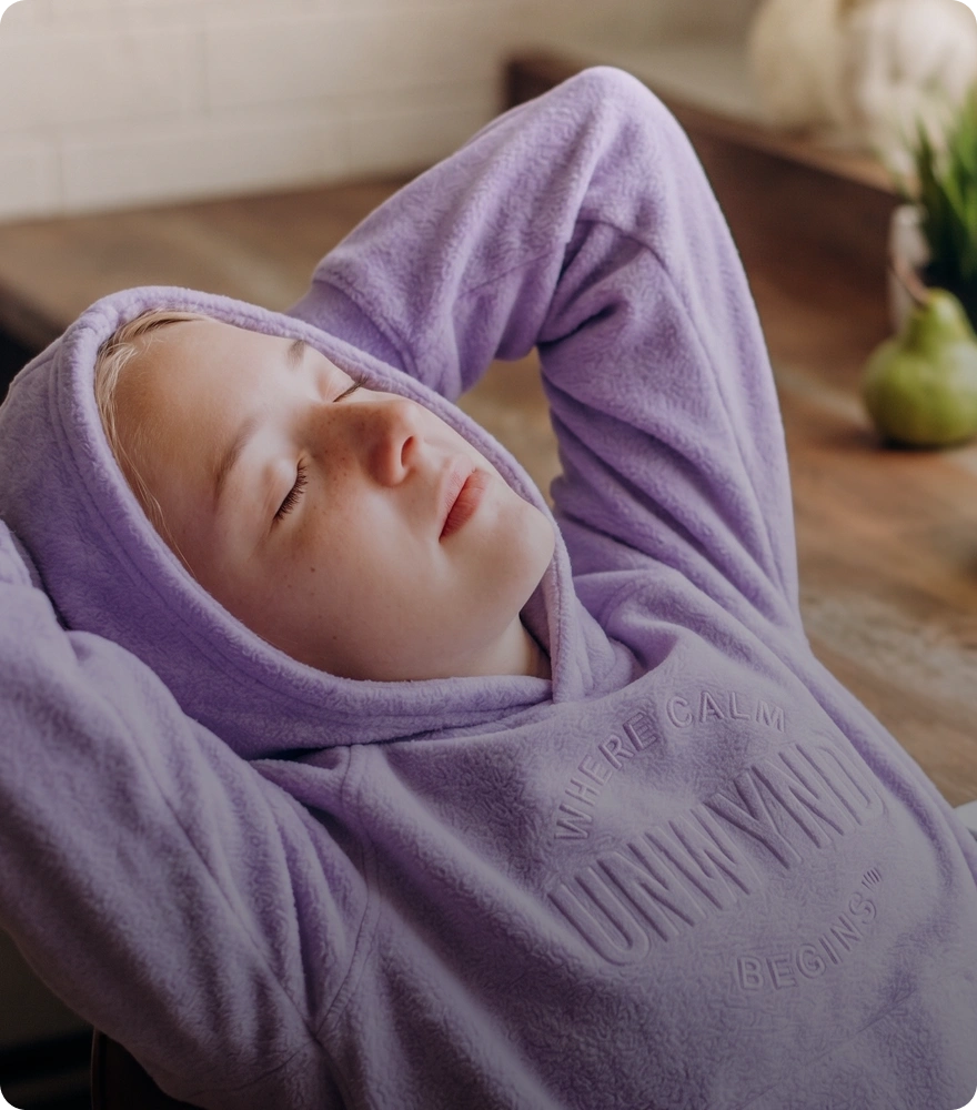 girl wearing hoodie relaxing with their eyes closed